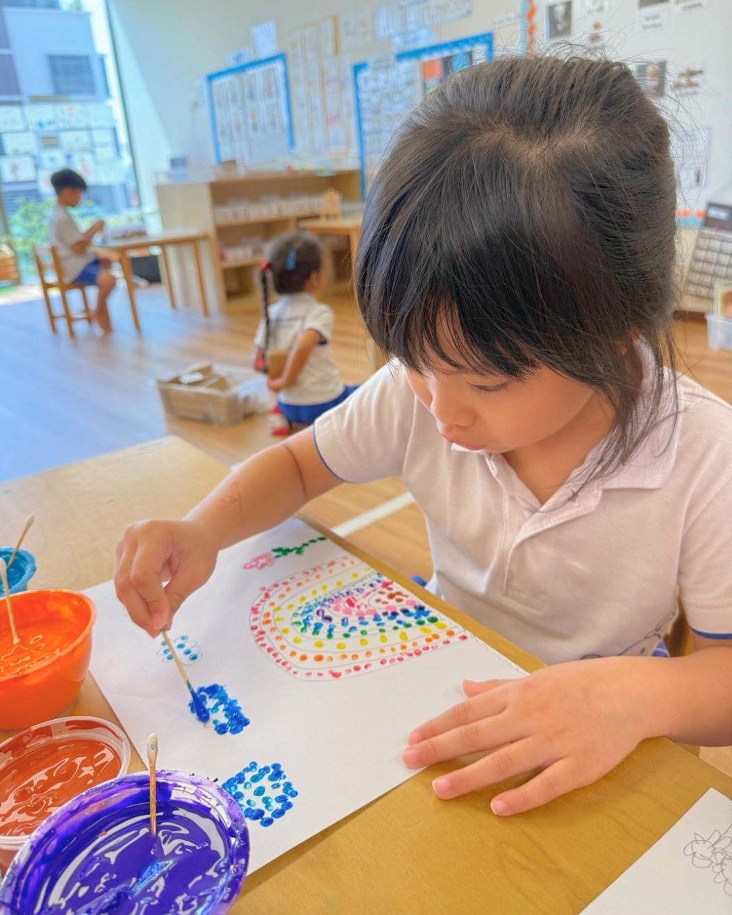 Child learning pointillism art technique